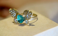 IGI Certified 1.3 Ct Emerald Queen Butterfly Ring with Diamonds in 18 Ct Gold Half Bezel (Available online and also to View in Person at Stardust, London 101 Walton Street)