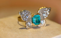 IGI Certified 1.3 Ct Emerald Queen Butterfly Ring with Diamonds in 18 Ct Gold Half Bezel (Available online and also to View in Person at Stardust, London 101 Walton Street)